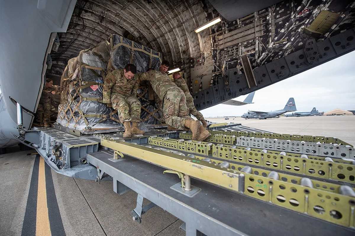 Logistics crew staging and loading palletized air cargo containers for long-haul inter-island air transit.
