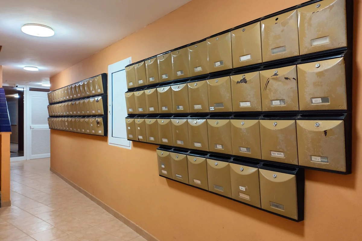 Mailboxes and parcel reception area in the common entrance lobby of a residential apartment building.