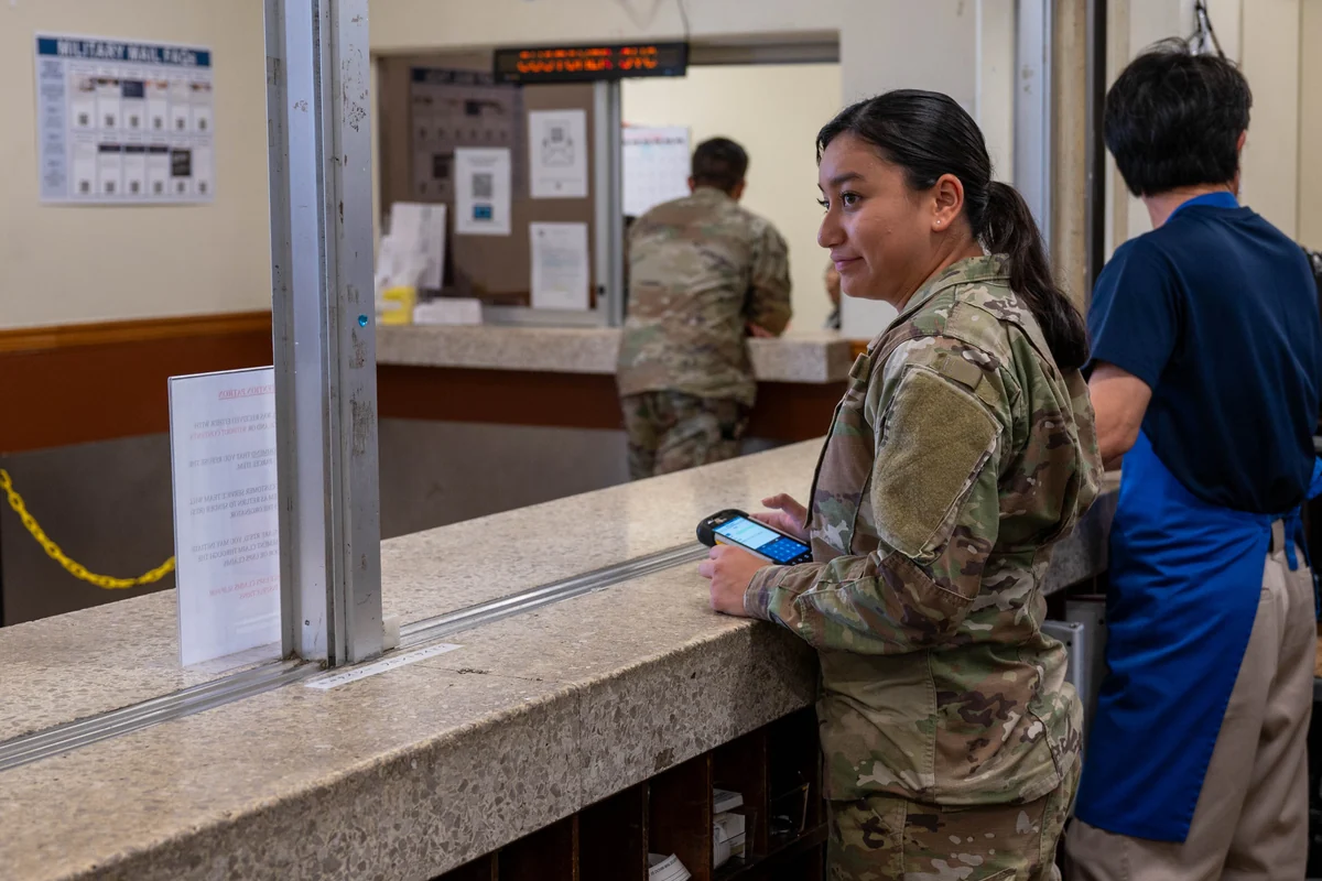 Customer presenting identification to branch teller to claim held package