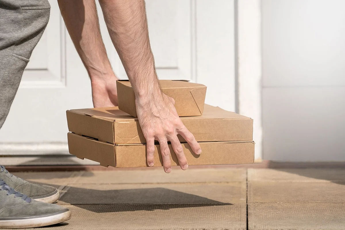 Delivery packages set down outside a residential entrance.
