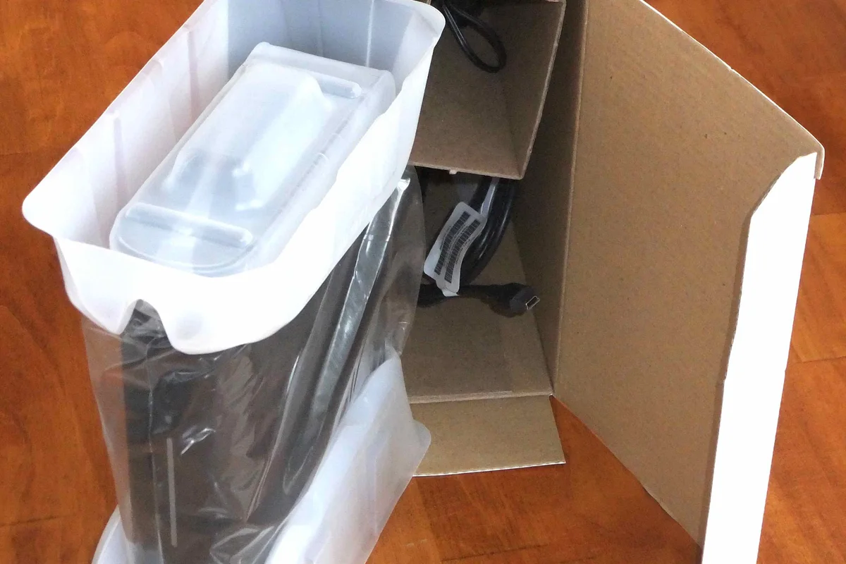 Fragile electronic components cushioned inside protective shock-absorbing packaging within corrugated box