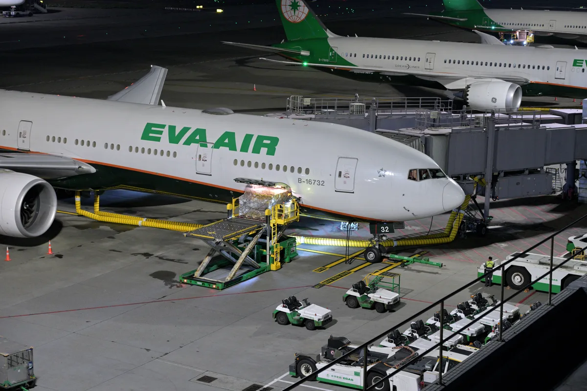 Palletized air cargo containers being loaded into the cargo hold of an international transport aircraft