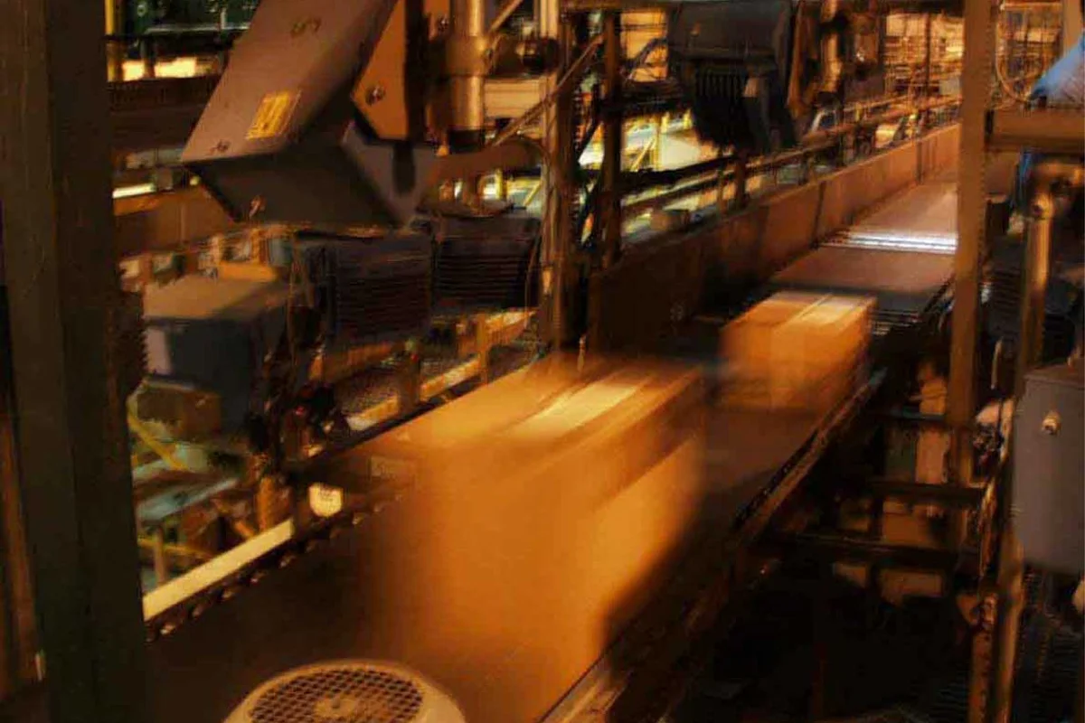 Automated parcel conveyor sorting line directing merchant shipping boxes through logistics hub