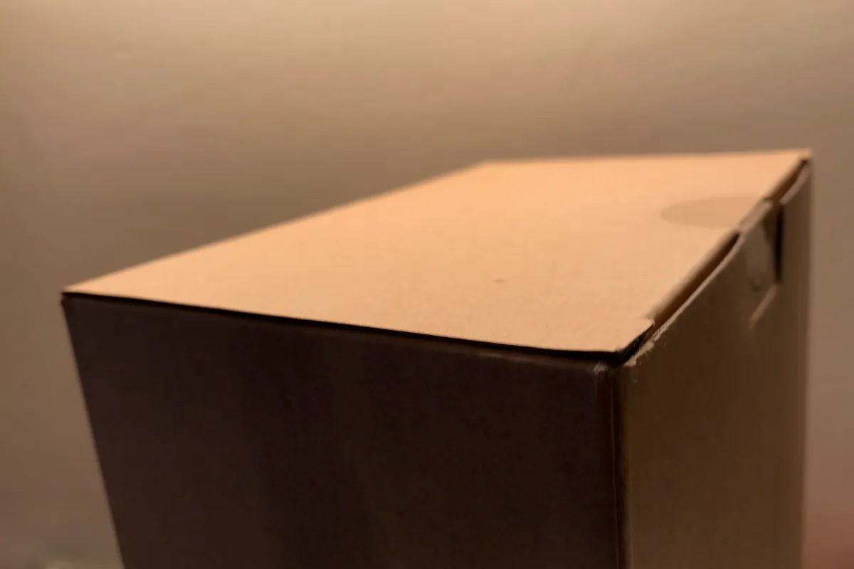 Cardboard shipping box secured with tamper-evident security tape seal to prevent parcel manipulation